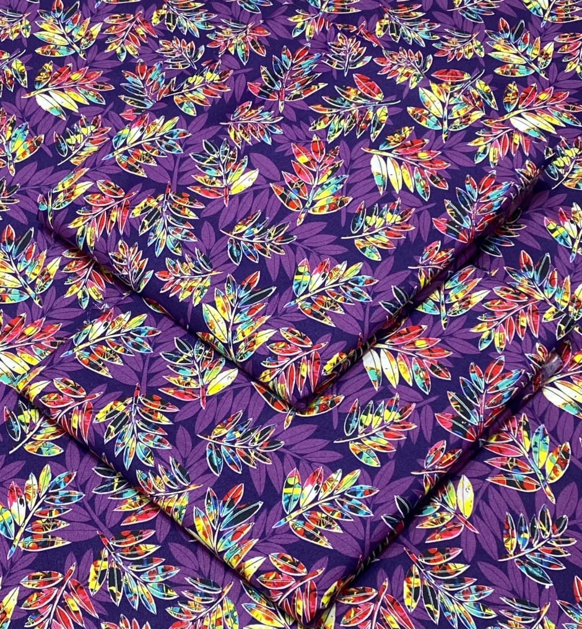 Colorful leaf pattern on purple fabric
