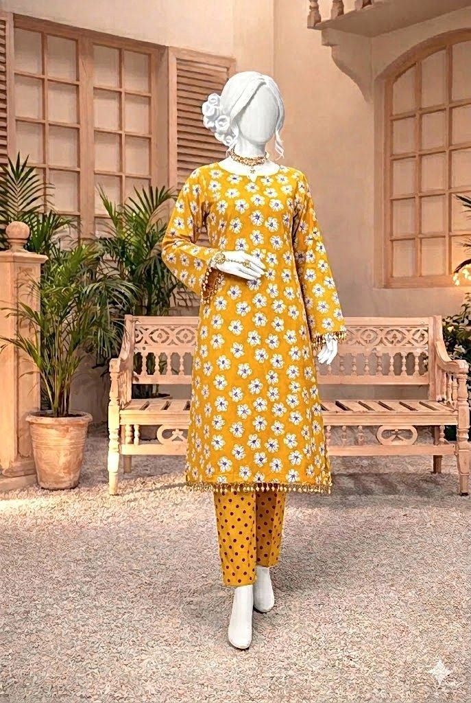 Mannequin wearing a yellow floral outfit in a decorative indoor setting with plants and wooden furniture.