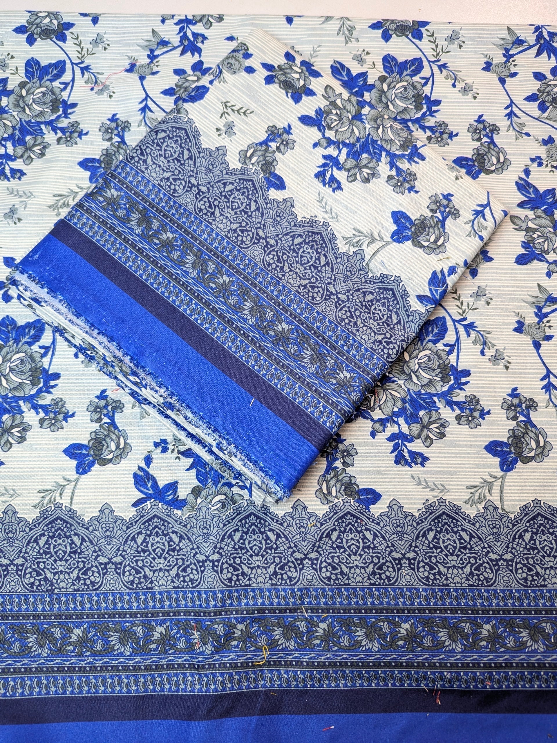 Blue and white floral fabric with intricate patterns on a flat surface