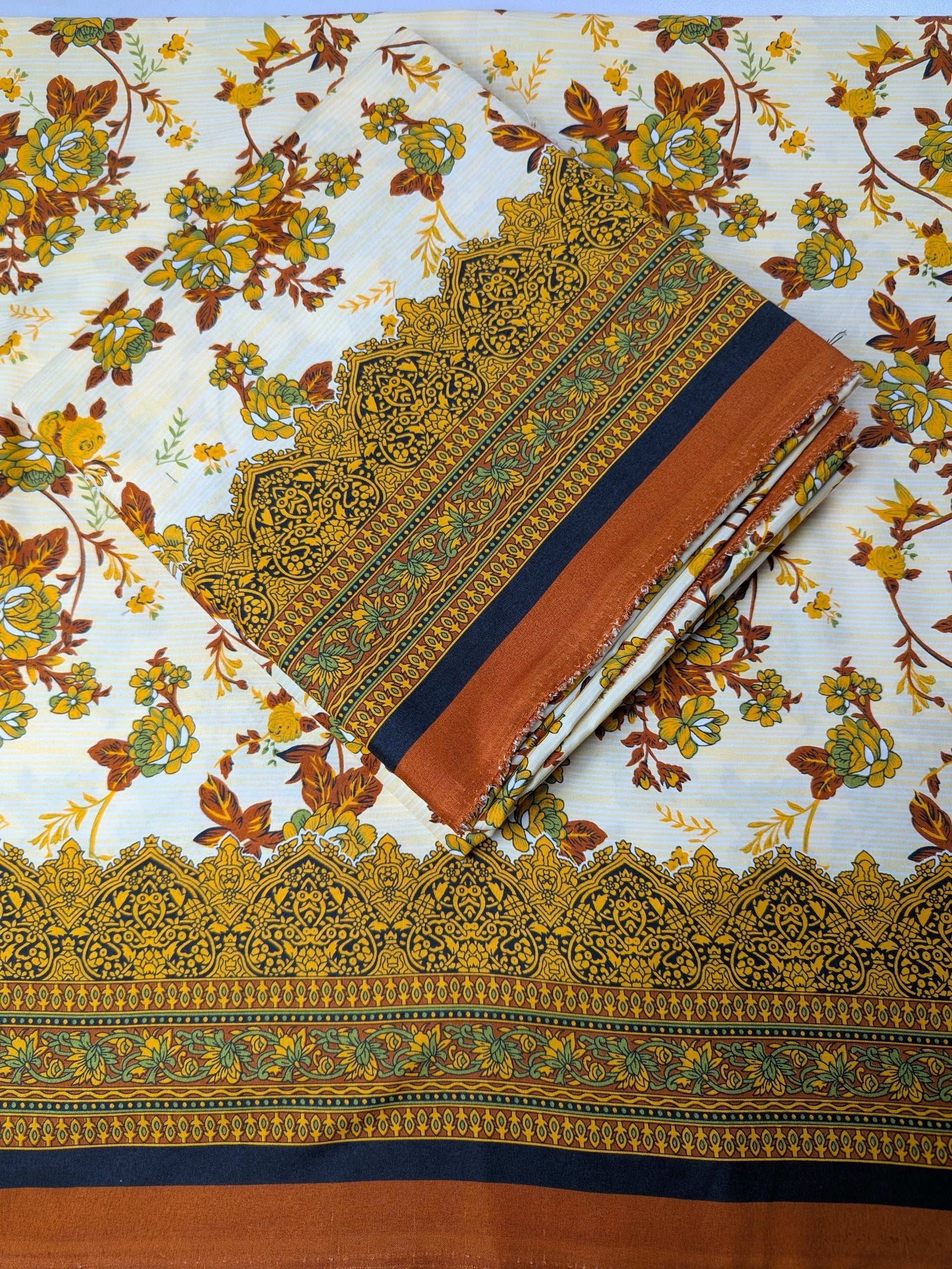 Traditional fabric with intricate patterns and embroidery on a floral background