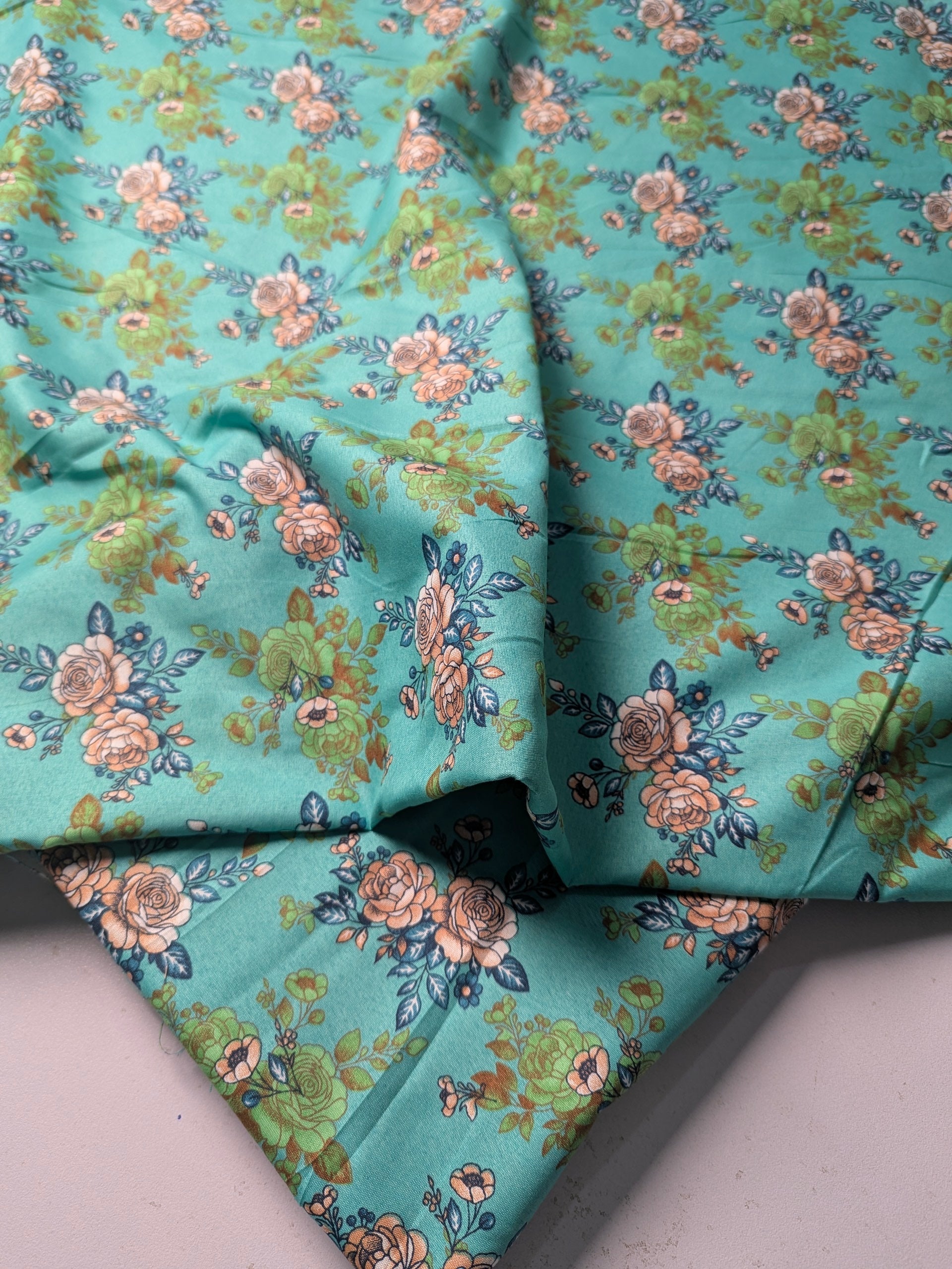 Floral patterned fabric with a turquoise background