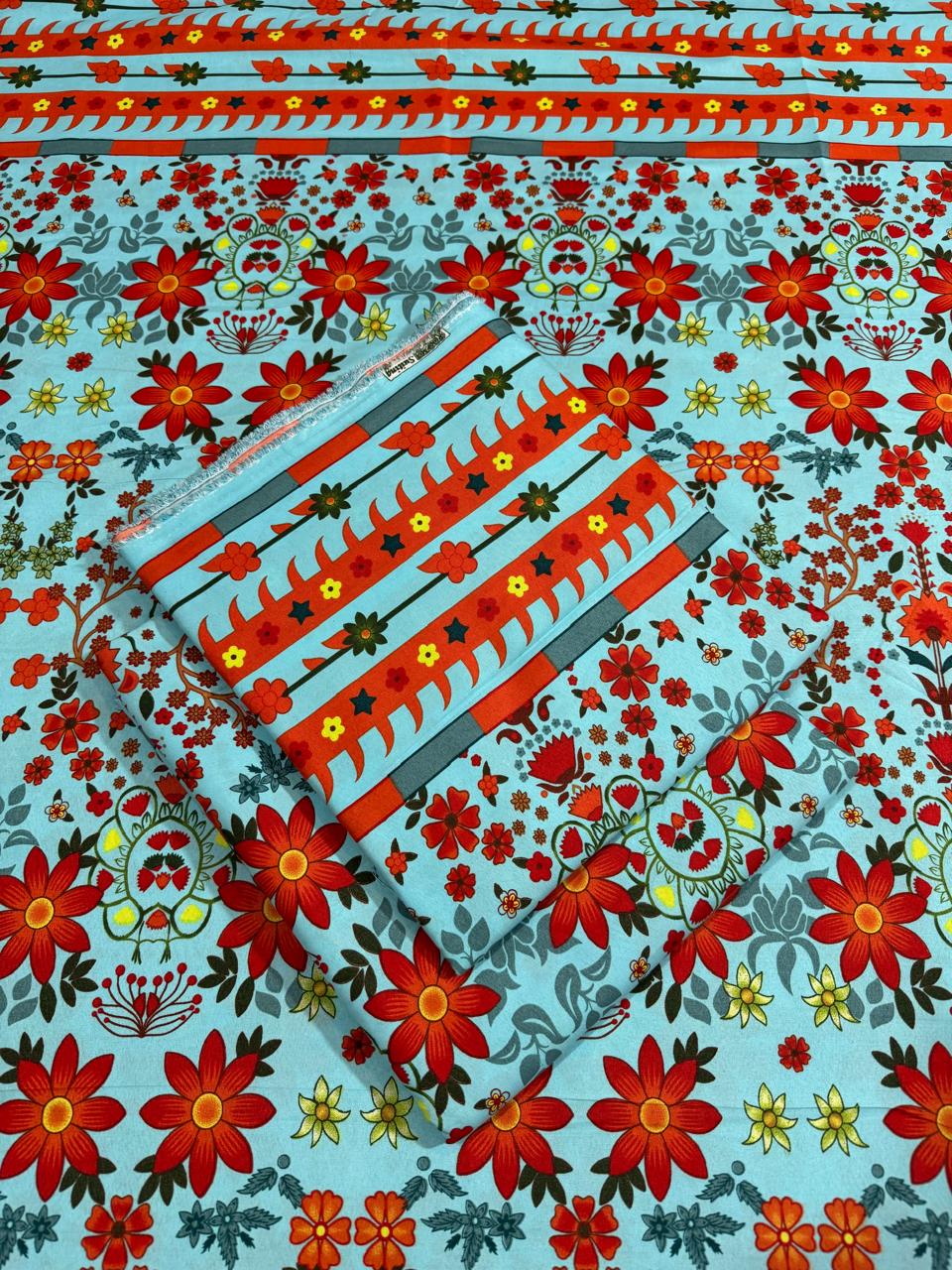 Floral patterned fabric with red flowers and blue background