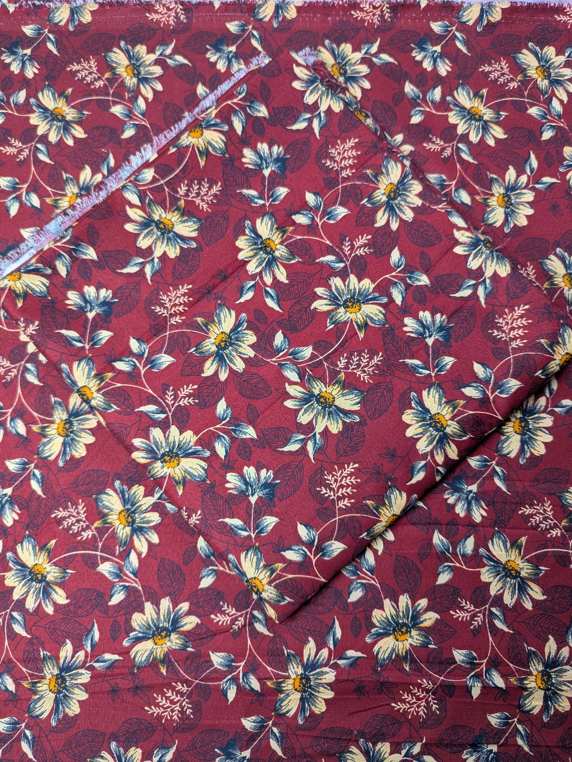 Floral fabric pattern with white flowers on a red background
