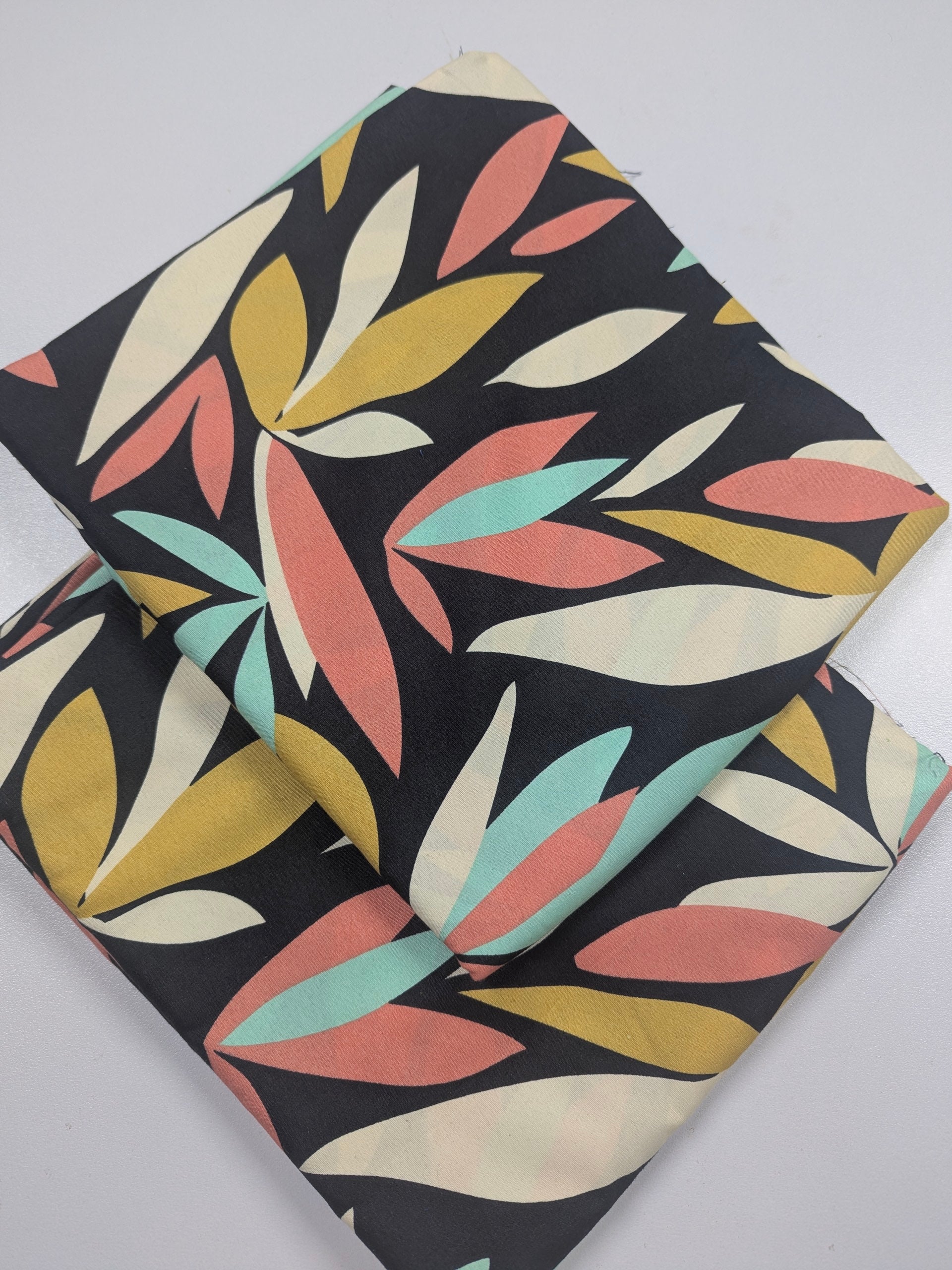 Fabric with colorful leaf pattern on a black background