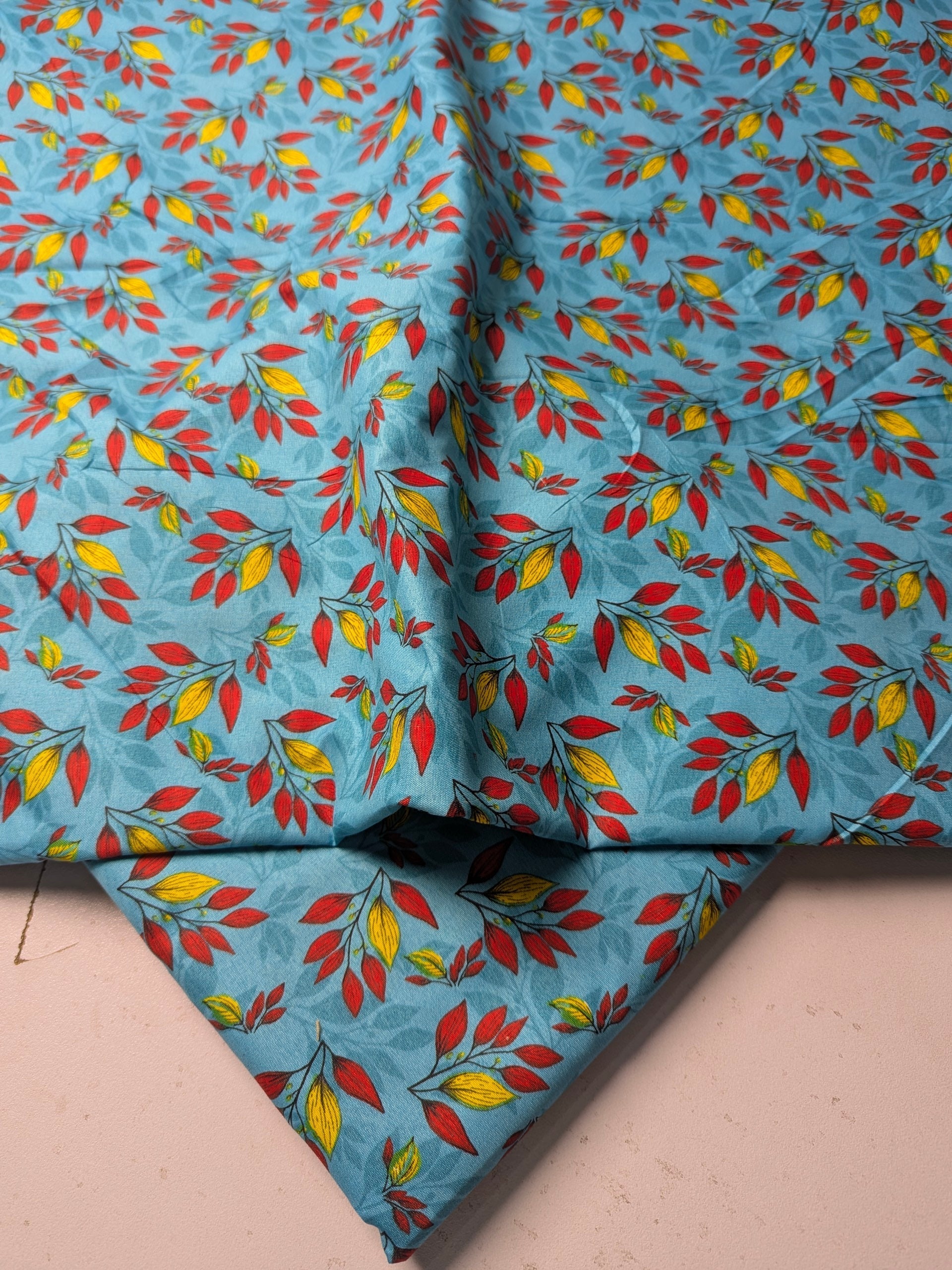 Fabric with colorful leaf pattern on a blue background