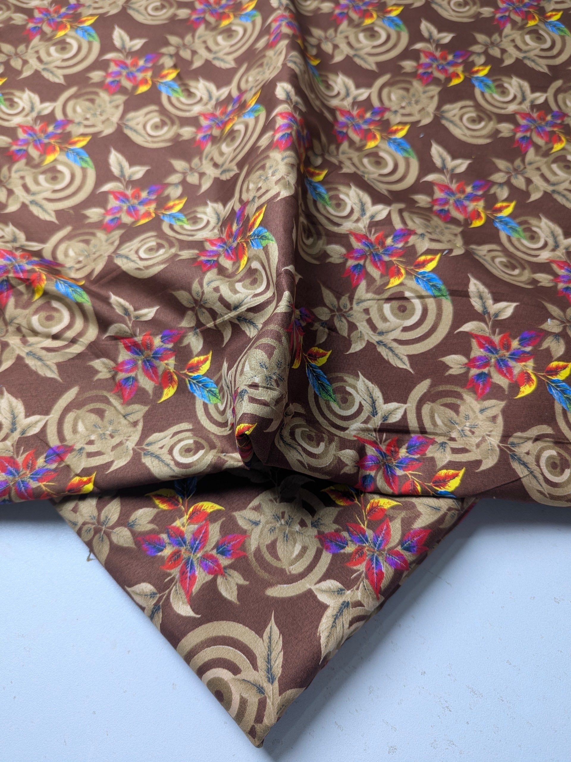 Brown fabric with colorful floral patterns on a white background