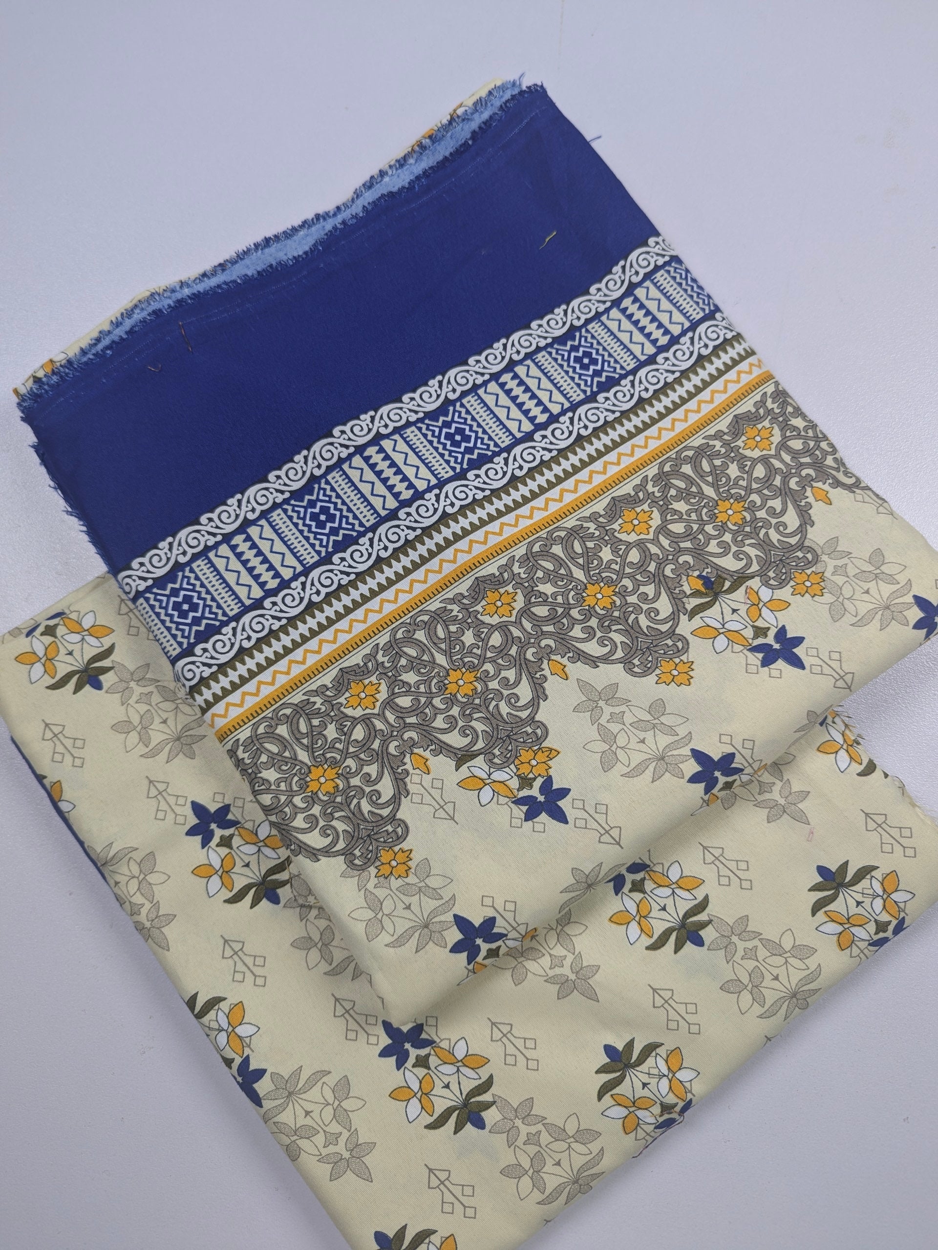 Two pieces of fabric with floral patterns on a white background