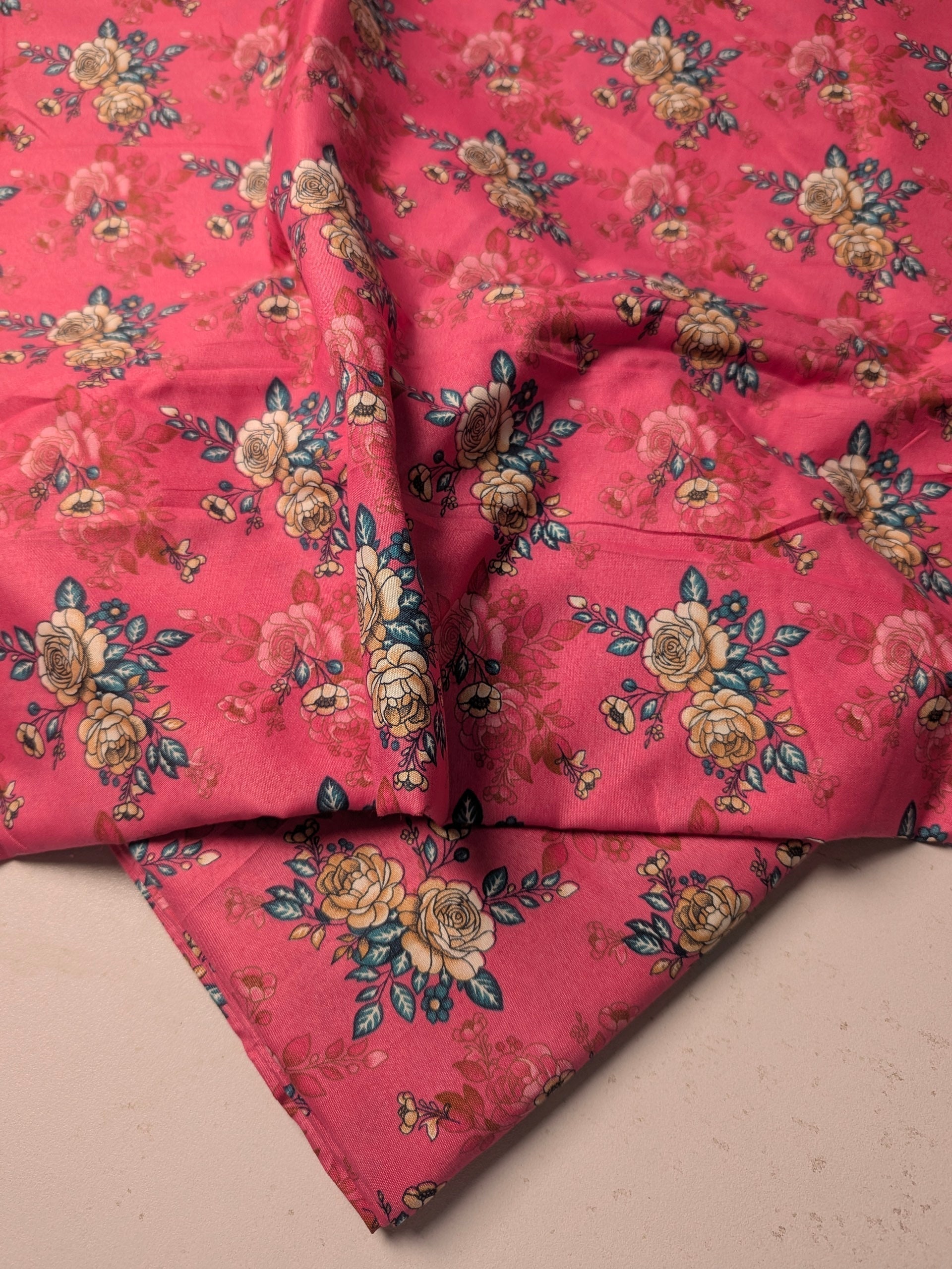 Floral patterned fabric on a pink background