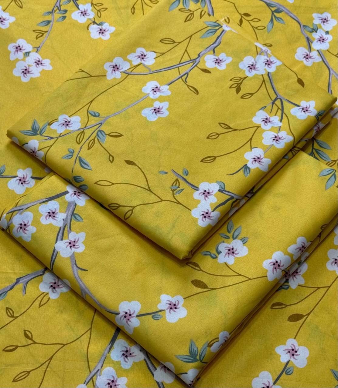 Yellow fabric with floral pattern on a yellow background