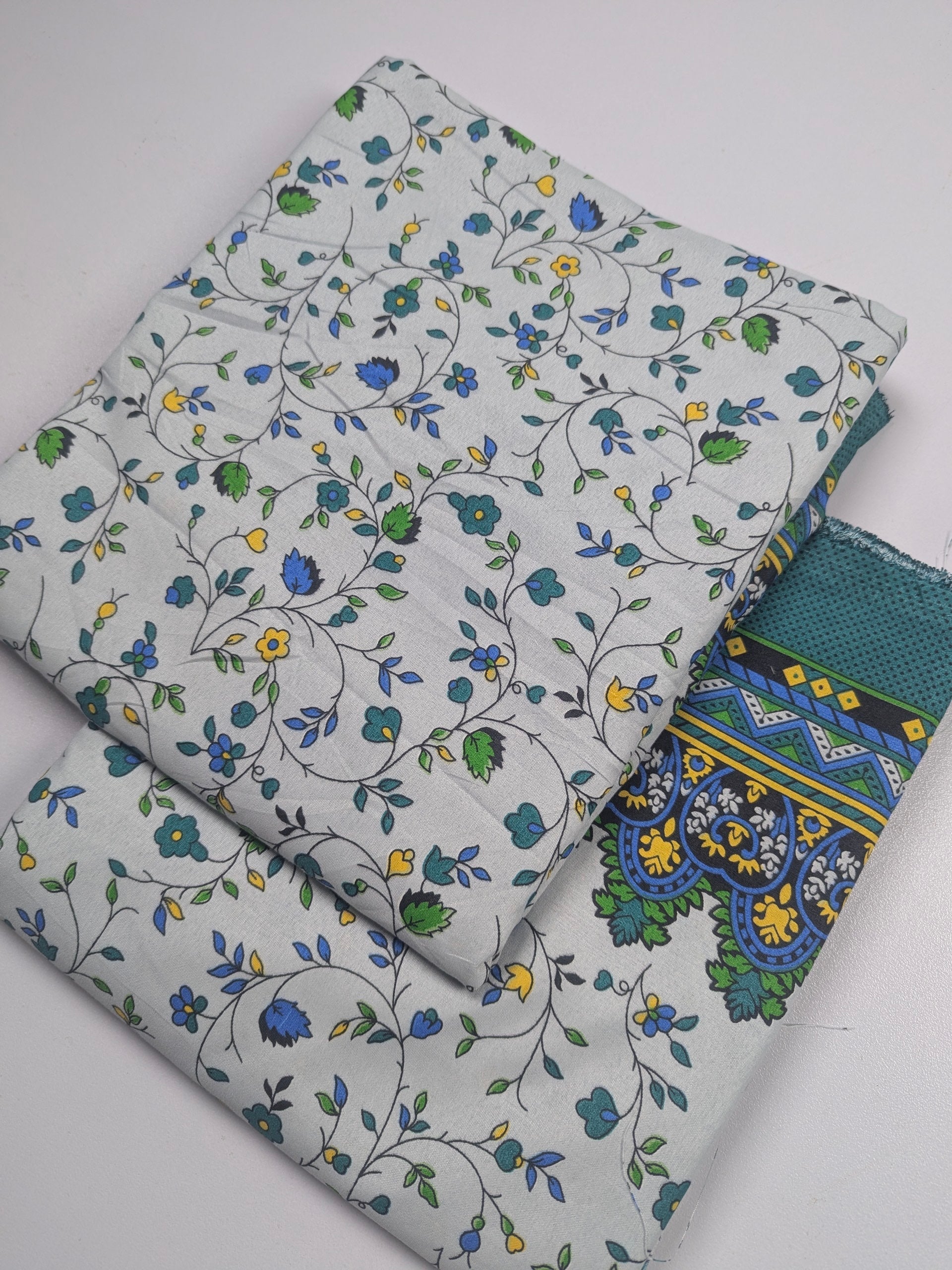 Two fabric swatches with floral patterns on a light gray background