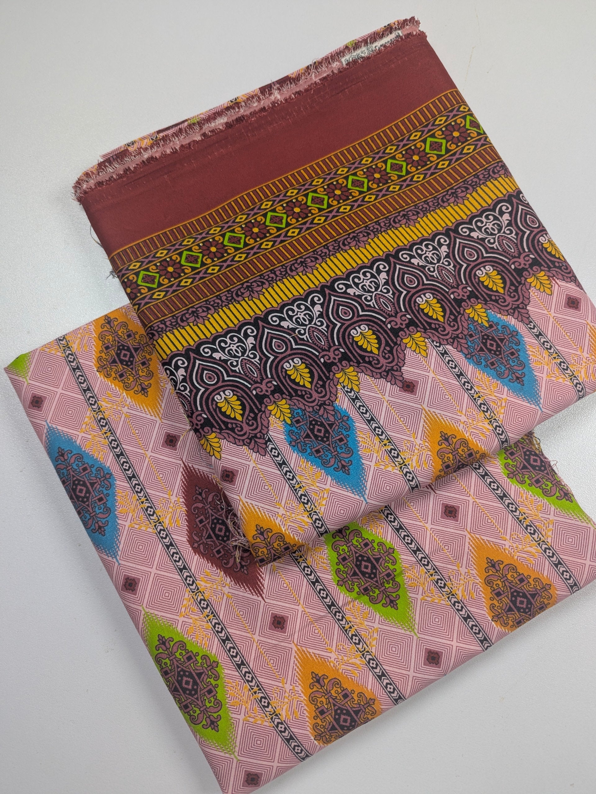 Two patterned fabric swatches on a white background